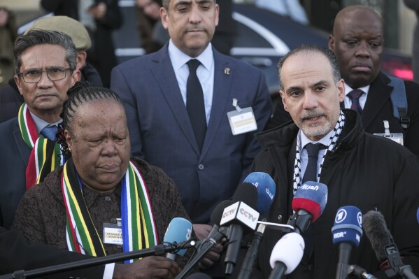 Accompanied with South Africa's Foreign Minister Naledi Pandor, left, Palestinian assistant Minister of Multilateral Affairs Ammar Hijazi addresses reporters after session of the International Court of Justice, or APCourt, in The Hague, Netherlands, Friday, Jan. 26, 2024. The United Nations' top court has stopped short of ordering a cease-fire in Gaza in a genocide case but demanded that Israel try to contain death and damage in its military offensive in the tiny coastal enclave. South Africa brought the case and had asked the court to order Israel to halt its operation. (APPhoto/Patrick Post)