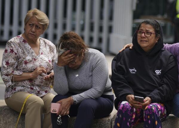 People gather outside after a magnitude 7.6 earthquake was felt in Mexico City, Monday, Sept. 19, 2022. The quake hit at 1:05 p.m. local time, according to the U.S. Geologic Survey, which said the quake was centered near the boundary of Colima and Michoacan states. (AP Photo/Fernando Llano)