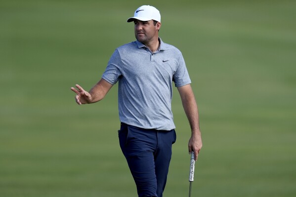 Scottie Scheffler waves to the crowd on the 18th green during the second round of The Sentry golf event, Friday, Jan. 5, 2024, at Kapalua Plantation Course in Kapalua, Hawaii. (AP Photo/Matt York)