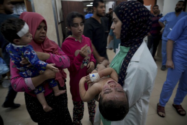 Palestinians wounded in the Israeli bombardment of the Gaza Strip are brought to a hospital in Deir al-Balah on Tuesday, Nov. 14, 2023. (AP Photo/Hatem Moussa)