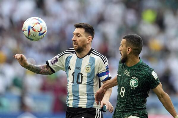 Argentina's Lionel Messi,left, and Saudi Arabia's Abdulelha Al-Malki, fight for the ball during the World Cup group C soccer match between Argentina and Saudi Arabia at the Lusail Stadium in Lusail, Qatar, Tuesday, Nov. 22, 2022. (AP Photo/Ebrahim Noroozi)