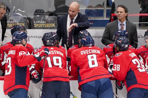 Washington Capitals coach Spencer Carbery speaks to players during a break in play during the third period of the team's NHL preseason hockey game against the Detroit Red Wings, Thursday, Sept. 28, 2023, in Washington. (AP Photo/Andrew Harnik)