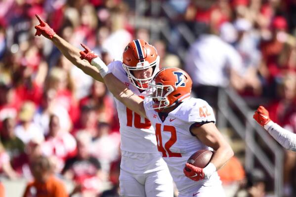 Illinois' Luke  Zardzin (42) celebrates recovering a Wisconsin fumble with defensive back Peyton Vining (16) during the second half of an NCAA college football game Saturday, Oct. 1, 2022, in Madison, Wis. (AP Photo/Kayla Wolf)