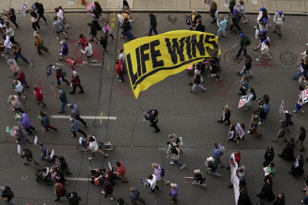 FILE - Marchers move down Front Street during the Ohio March for Life after a rally at the Ohio State House in Columbus, Ohio, Friday, Oct. 6, 2023. (AP Photo/Carolyn Kaster, File)