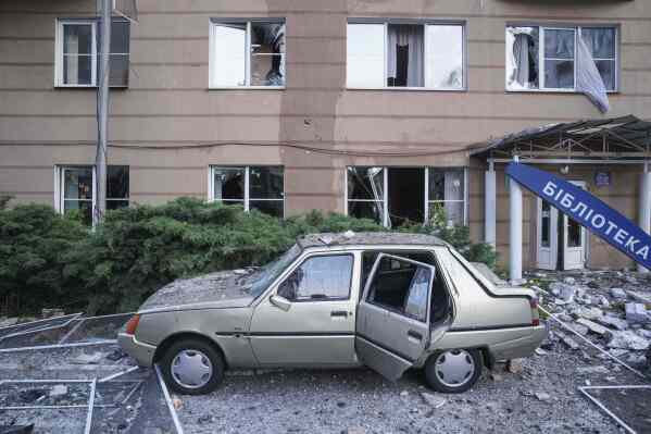 A car is seen damaged in front of a residential multi-storey building damaged after a Russian drone strike on Kyiv, Ukraine, on Friday, June 6, 2025. (AP Photo/Evgeniy Maloletka)