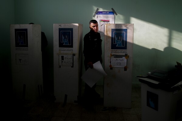 Iraqi security forces members participate in the provincial elections in Najaf, Iraq, Saturday, Dec. 16, 2023. (AP Photo/Anmar Khalil)