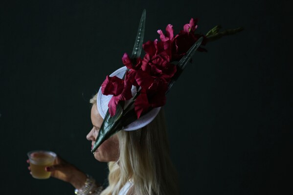 A race fan walk through a tunnel at Churchill Downs before the 151st running of the Kentucky Oaks horse race Friday, May 2, 2025, in Louisville, Ky. (AP Photo/Brynn Anderson)