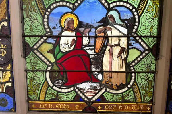 Stained glass window shows Jesus Christ with dark skin, stirring