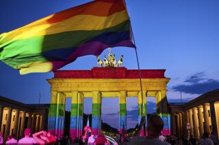 FILE - Brandenburg Gate in Berlin is illuminated in rainbow colors, Sunday, June 26, 2022. The German government on Tuesday presented a proposal for a law that will make it easier for transgender people to legally change their name and gender, ending decades-old rules that require them to get expert assessments and a court’s authorization.(Annette Riedl/dpa via AP, File)