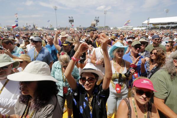 Fans cheer at the New Orleans Jazz & Heritage Festival in New Orleans, Thursday, May 2, 2019. After a two-year hiatus brought on by the coronavirus pandemic, the New Orleans Jazz & Heritage Festival returns this spring with headliners The Who, Stevie Nicks, Foo Fighters, Lionel Richie, Erykah Badu, Ludacris, Nelly and Willie Nelson. Festival organizers announced the lineup for the festival Thursday, Jan. 20, 2022. (AP Photo/Gerald Herbert)
