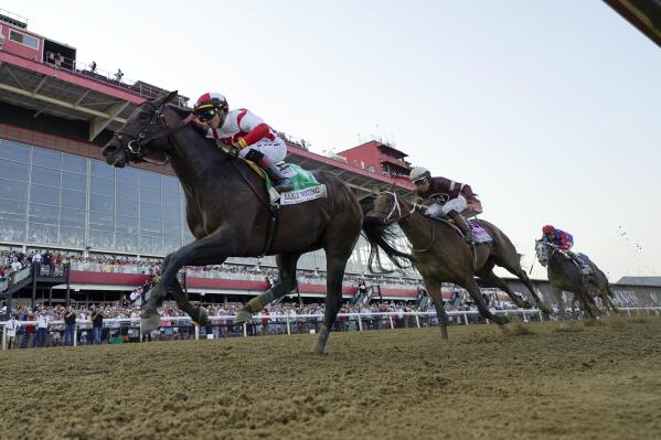 Jose Ortiz, left, atop Early Voting, edges out Joel Rosario, second from right, atop Epicenter, and Brian Hernandez Jr., right, atop Creative Minister, to win during the 147th running of the Preakness Stakes horse race at Pimlico Race Course, Saturday, May 21, 2022, in Baltimore. (AP Photo/Julio Cortez)