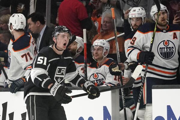 PHOTO: Kings mascot offers Oilers 'Hockey for Dummies' book during blowout