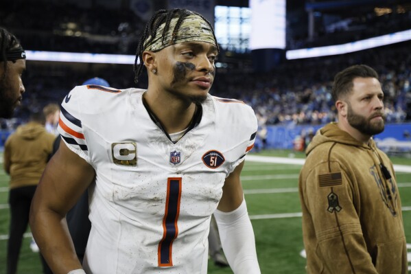 Chicago Bears quarterback Justin Fields walks off the field after the second half of an NFL football game against the Detroit Lions, Sunday, Nov. 19, 2023, in Detroit. (AP Photo/Duane Burleson)