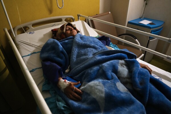 Mahdieh Sazmand, who was injured in Wednesday's bombing, lies in bed at Bahonar Hospital in the city of Kerman, about 510 miles (820 kilometers) southeast of the Iranian capital, Tehran, on Thursday, Jan. 4, 2024.  Investigators believe suicide bombers may have carried out the blast.  An attack in memory of an Iranian general killed in a 2020 US drone strike, state media reported on Thursday, as Iran grapples with its biggest mass-casualty attack in decades and the wider Mideast remains on edge.  (AP Photo/Vahid Salemi)
