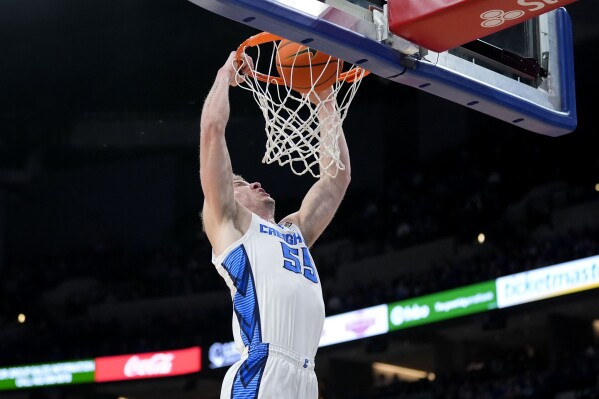 Creighton guard Baylor Scheierman (55) dunks the ball during the first half of an NCAA college basketball game against Xavier, Tuesday, Jan. 23, 2024, in Omaha, Neb. (AP Photo/Charlie Neibergall)