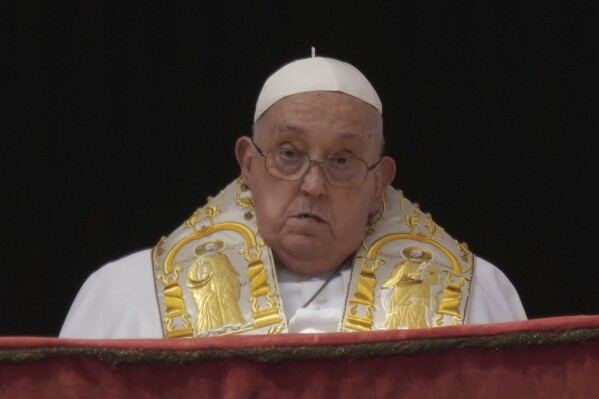 Pope Francis appears on the central lodge of St. Peter's Basilica to bestow the Urbi et Orbi (Latin for to the city and the world) blessing at the end of the Easter mass in St. Peter's Square at the Vatican Sunday, April 20, 2025. (AP Photo/Andrew Medichini, File)