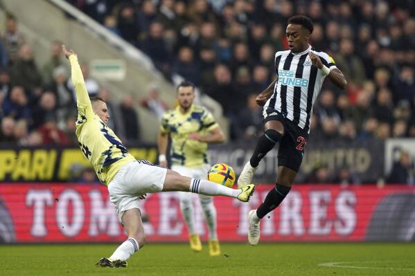 Leeds' Adam Forshaw, left, and Newcastle's Joe Willock battle for the ball during the English Premier League soccer match between Newcastle United and Leeds United at St. James' Park, Newcastle upon Tyne, England, Saturday, Dec. 31, 2022. (Owen Humphreys/PA via AP)