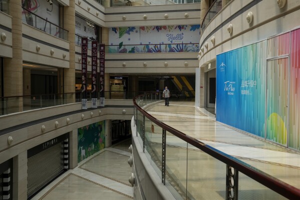 A man tour by a deserted shopping mall in Beijing on Thursday, July 27, 2023. Chinese leader Xi Jinping’s government is promising to drag the economy out of a crisis of confidence aggravated by tensions with Washington, wilting exports, job losses and anxiety among foreign companies about an expanded anti-spying law.(AP Photo/Andy Wong)