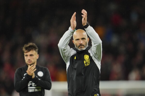 FILE - Leicester's head coach Enzo Maresca applauds fans at the end of the English League Cup third round soccer match between Liverpool and Leicester City at the Anfield stadium in Liverpool, England, Wednesday, Sept. 27, 2023. There is unprecedented managerial upheaval in the English Premier League. Five of the top 11 teams potentially will have new coaches at the start of next season and another of them changed managers just three months ago. (AP Photo/Jon Super, File)