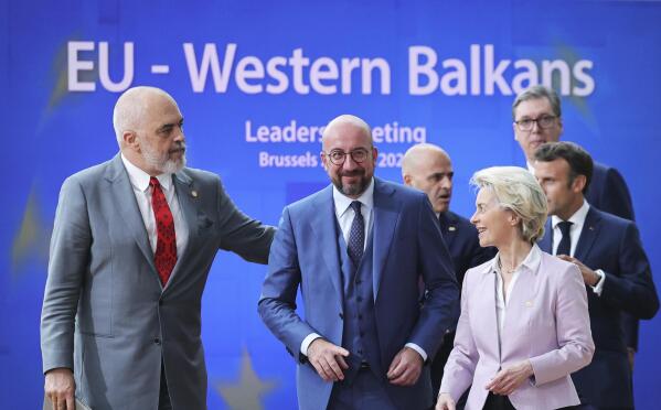 FILE - From left, Albanian Prime Minister Edi Rama, European Council President Charles Michel, North Macedonia's Prime Minister Dimitar Kovacevski, European Commission President Ursula von der Leyen, Serbian President Aleksandar Vucic and French President Emmanuel Macron walk to a group photo during an EU summit in Brussels, on June 23, 2022. The European Union is in the midst of yet another goodwill trip through the neighboring Western Balkans in its drive to drum up support for the bloc and to make sure that the historical tinderbox is not about to pick the side of hostile Russia or strategic rival China in the geopolitical fight. (AP Photo/Olivier Matthys, File)