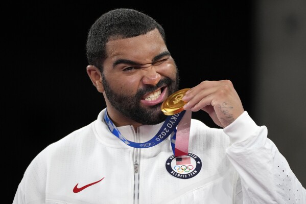 FILE - United State's Gable Dan Steveson poses with his gold medal during the medal ceremony for the men's freestyle 125kg wrestling at the 2020 Summer Olympics, in Chiba, Japan, Aug. 6, 2021. Olympic gold medal wrestler Gable Steveson is trading the mat for the gridiron by signing contract with the Buffalo Bills on Friday, May 31, 2024. (AP Photo/Aaron Favila, File)