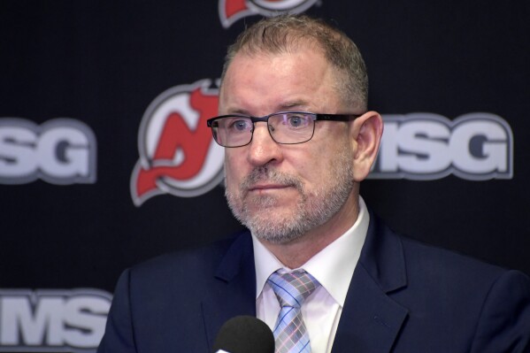 FILE - New Jersey Devils general manager Tom Fitzgerald speaks during an NHL hockey news conference, Tuesday, Nov. 30, 2021, in Newark, N.J. Fitzgerald is looking for a new coach for the Devils and interim skipper Travis Green remains in the running for the job. (AP Photo/Bill Kostroun, File)