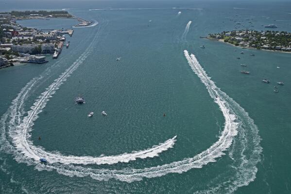 In this aerial photo provided by the Florida Keys News Bureau, offshore raceboats make the turn in the harbor Wednesday, Nov. 10, 2021, during the first day of competition at the Race World Offshore Key West Championships in Key West, Fla. Almost 50 boats are competing in the event to determine world titles for powerboat racers in 14 different classes. The contest continues Friday Nov. 12, with the finals set for Sunday, Nov. 14. (Rob O'Neal/Florida Keys News Bureau via AP)