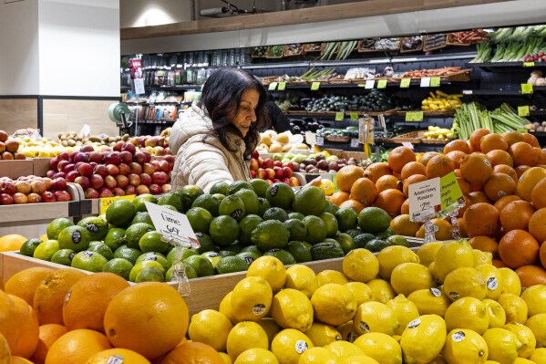 FILE - A woman browses produce for sale at a grocery store, Friday, Jan. 19, 2024, in New York. In final rule changes announced Tuesday, April 9, 2024, the federal program that helps millions of low-income mothers, babies and young kids will soon emphasize more fruits, vegetables and whole grains, as well as provide a wider choice of foods from different cultures. (AP Photo/Peter K. Afriyie, File)