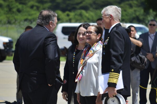 In this photo provided by La Oficina de Prensa, Casa Presidencial El Salvador, U.S. Secretary of State Mike Pompeo, left, talks with Alexandra Hill, Salvadoran Foreign Minister, second right, and U.S. Ambassador to El Salvador Jane Manes, second left, in San Salvador, El Salvador, Sunday, Jul. 21, 2019. (Oficina de Prensa Casa Presidencial El Salvador via AP)
