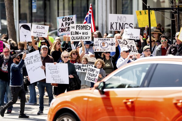 Protesters rally against Tesla CEO Elon Musk outside a Tesla store in San Francisco on Saturday, March 29, 2025. (AP Photo/Noah Berger)