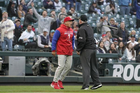 Home plate umpire Bill Miller, left, turns away from Philadelphia