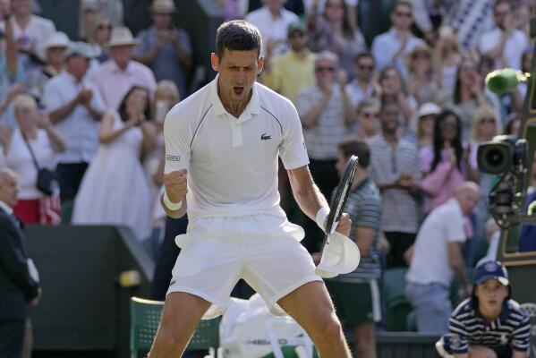 Serbia's Novak Djokovic celebrates after beating Britain's Cameron Norrie in a men's singles semifinal on day twelve of the Wimbledon tennis championships in London, Friday, July 8, 2022. (AP Photo/Alastair Grant)