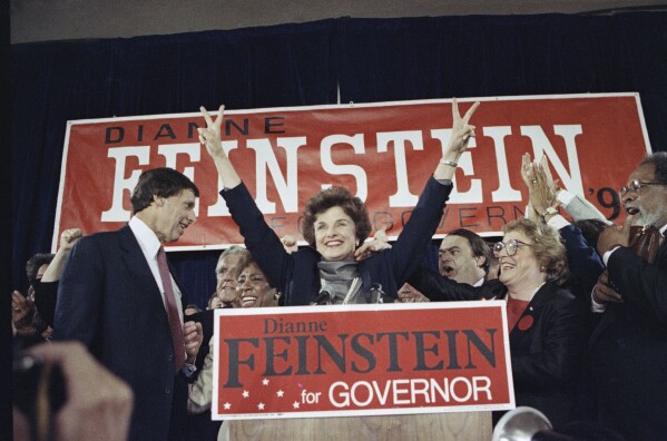 FILE - Democratic gubernatorial candidate Dianne Feinstein waves to supporters at the Fairmont Hotel in San Francisco, June 6, 1990, after winning her party's nomination for governor in the California June primary election against John Van de Kamp. At left is her husband, Richard Blum. (AP Photo/Paul Sakuma, File)