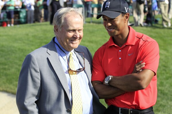 In this Sunday, June 3, 2012, file photo, Jack Nicklaus, left, talks with Tiger Woods after Woods won the Memorial golf tournament at the Muirfield Village Golf Club in Dublin, Ohio. (AP Photo/Tony Dejak, File)
