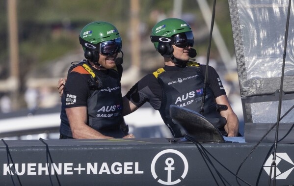 Tom Slingsby, CEO and driver of Australia SailGP Team, and Kyle Langford, wing trimmer, celebrate as they win the KPMGAustralia Sail Grand Prix in Sydney, Australia. Sunday, Feb. 25, 2024. (Felix Diemer/SailGP via AP)