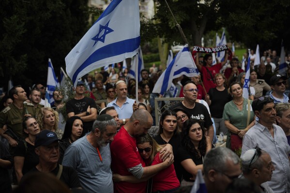 Mourners attend the funeral of Sgt. Roni Eshel in Kfar Saba, Israel, Sunday Nov. 12, 2023. Eshel was killed during Hamas' bloody cross-border rampage on Oct. 7, 2023. At least 1,200 people were killed and some 240 captured in an unprecedented, multi-front attack on Israel by the militant group that rules Gaza. (AP Photo/Ariel Schalit)