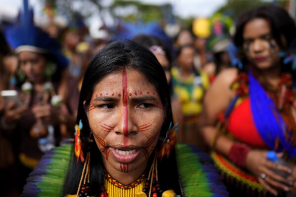 Indigenous people march during the annual Free Earth camp, where they discuss rights, territorial protection and their role in COP30 which will take place for the first time in the Amazon, in Brasilia, Brazil, Tuesday, April 8, 2025. (AP Photo/Eraldo Peres)