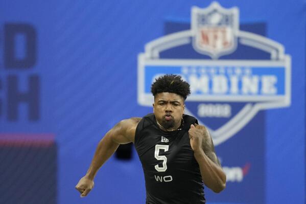 FILE - Arkansas wide receiver Treylon Burks runs the 40-yard dash at the NFL football scouting combine, Thursday, March 3, 2022, in Indianapolis. The Dallas Cowboys could be looking at their offensive line with their first pick in the NFL draft at No. 24. (AP Photo/Charlie Neibergall)