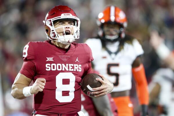 Oklahoma quarterback Dillon Gabriel (8) yells while scoring a touchdown during the first quarter of an NCAA college football game against Oklahoma State in Norman, Okla., Saturday, Nov. 19, 2022. (Ian Maule/Tulsa World via AP)