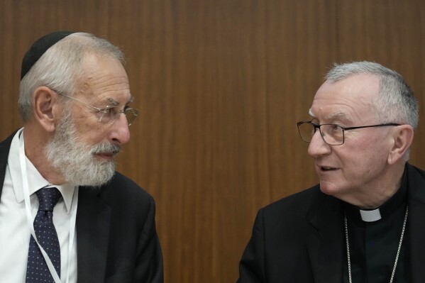 Rome's Chief Rabbi Riccardo Di Segni, left, talks to Vatican Secretary of State Pietro Parolin during the international conference 