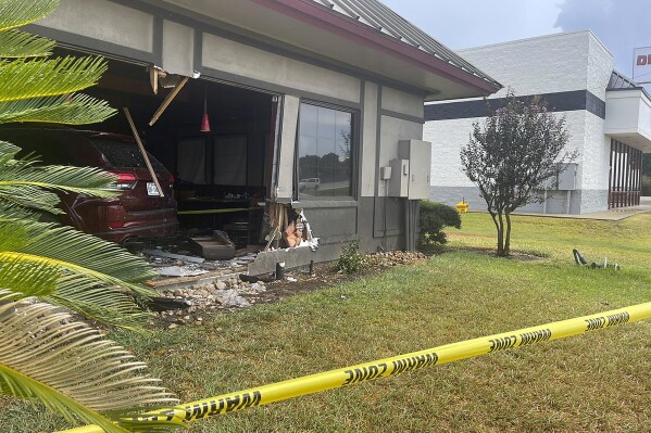 This image provided by the Rosenberg Police Department shows police tape in front of a Denny's restaurant after a vehicle crashed into it in Rosenberg, Texas, Monday, Sept. 4, 2023. (Rosenberg Police Department via AP)