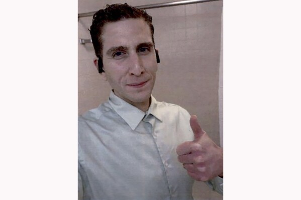 This photo released by the State of Idaho, which prosecutors claim to have been taken from Bryan Kohberger's phone, shows Kohberger, accused of slaying 4 University of Idaho students, gesturing in a selfie on Nov. 13, 2022, hours after the homicides occurred. (State of Idaho via AP)