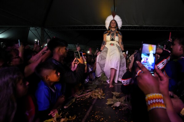 An Indigenous model wears a creation from Indigenous designers during a fashion event, as part of the Third March of Indigenous Women, to claim women's rights and the demarcation of Indigenous lands, in Brasilia, Brazil, Tuesday, Sept. 12, 2023. (AP Photo/Eraldo Peres)