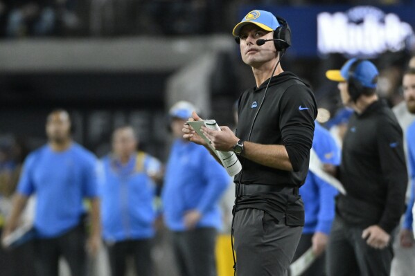 Los Angeles Chargers head coach Brandon Staley stands on the sidelines during the first half of an NFL football game against the Las Vegas Raiders, Thursday, Dec. 14, 2023, in Las Vegas. (AP Photo/David Becker)