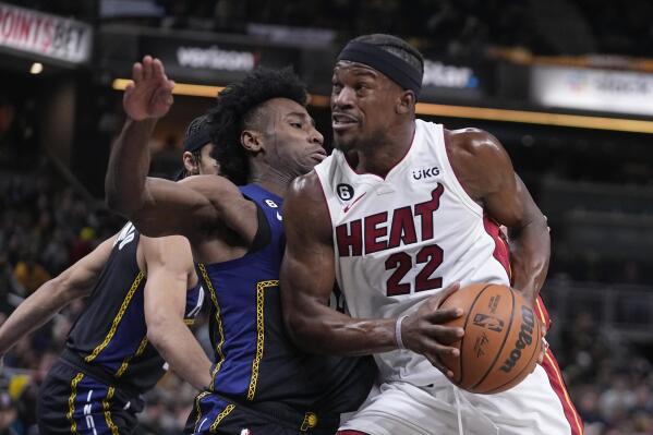 Miami Heat's Jimmy Butler (22) goes to the basket against Indiana Pacers' Aaron Nesmith, front left, during the first half of an NBA basketball game, Monday, Dec. 12, 2022, in Indianapolis. (AP Photo/Darron Cummings)