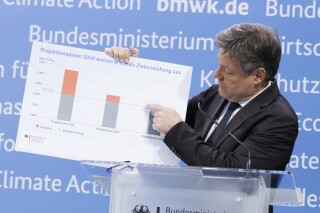 German Vice Chancellor Robert Habeck presents the greenhouse gas emissions data for 2023 and the projection data up to 2030 at a press conference in Berlin, Friday March 15, 2024. Germany's greenhouse gas emissions dropped by one-tenth last year as renewable energy grew in importance, the use of coal and gas diminished and economic pressures weighed on energy demand from business and consumers, official data showed Friday. Habeck, who is also the economy and climate minister, said Europe's biggest economy is on course to meet its target for 2030 of cutting emissions by 65% compared with 1990. (Carsten Koall/dpa via AP)
