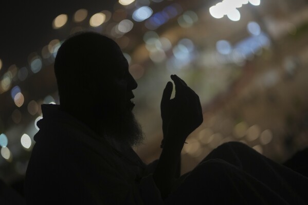A Muslim pilgrim prays during the annual Hajj pilgrimage on the Plain of Arafat, near the holy city of Mecca, Saudi Arabia, Thursday, June 5, 2025. (AP Photo/Amr Nabil)