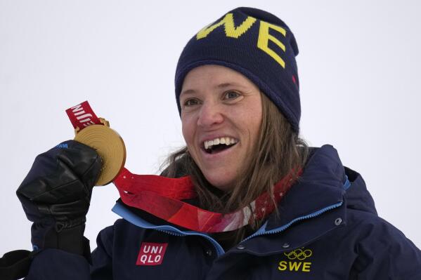 Sweden's Sara Hector celebrates on the podium with her gold medal for the women's giant slalom at the 2022 Winter Olympics, Monday, Feb. 7, 2022, in the Yanqing district of Beijing. (AP Photo/Luca Bruno)