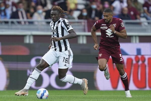 Juventus' Moise Kean, left, is challenged by Torino's Bremer during the Serie A soccer match between Juventus and Torino, at the Turin Olympic stadium, Italy, Saturday, Oct. 2, 2021. (Spada/LaPresse via AP)