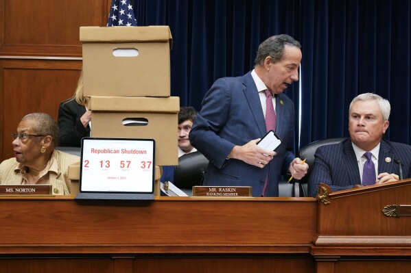 Oversight Committee Chair James Comer, R-Ky., seated right, talks with Ranking Member Rep. Jamie Raskin, D-Md., before the House Oversight Committee begins an impeachment inquiry into President Joe Biden, Thursday, Sept. 28, 2023, on Capitol Hill in Washington. Seated left is Del. Eleanor Holmes Norton, D-D.C. (AP Photo/Jacquelyn Martin)